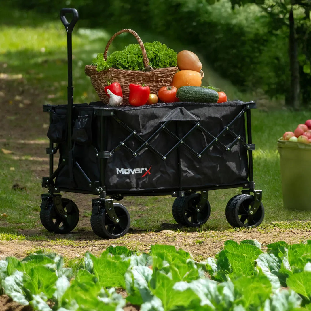 MoverX black foldable all-terrain garden trolley filled with a basket of fresh vegetables.