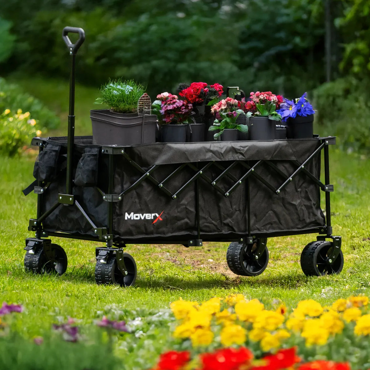 MoverX foldable all-terrain gardening trolley filled with potted flowers in a green garden